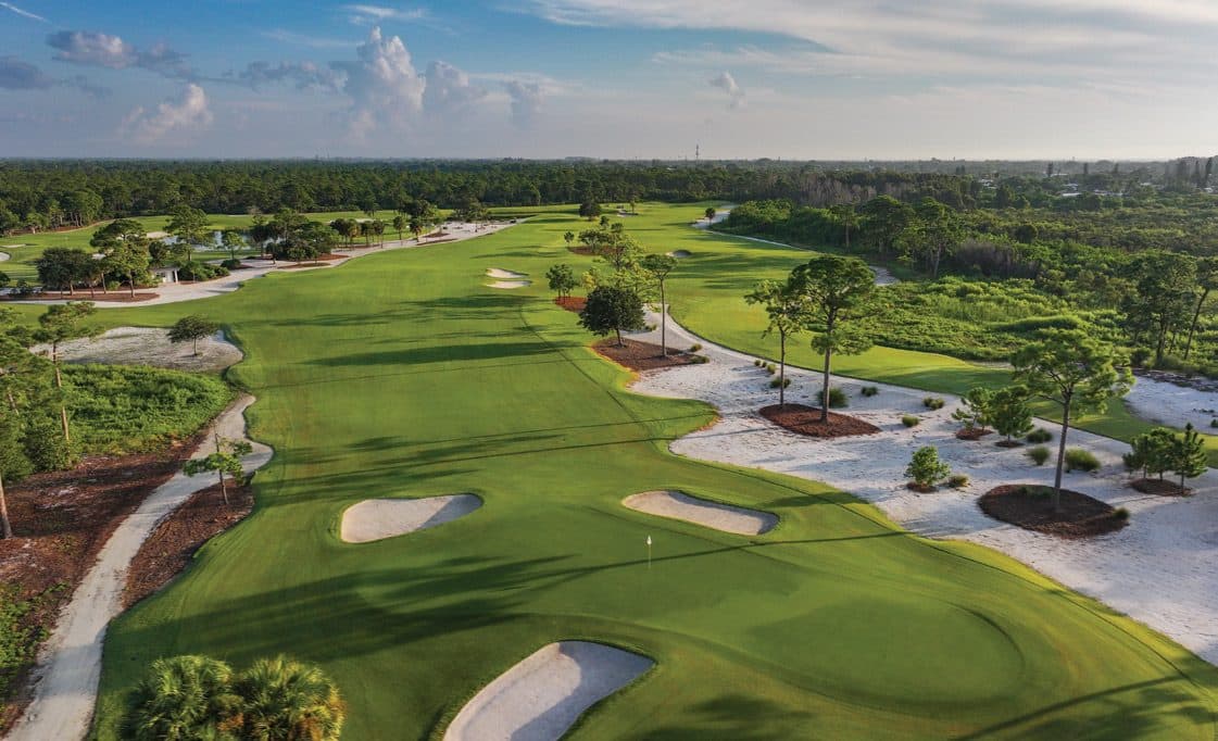 Aerial down a Hobe Sound fairway framed by white sand waste areas, bunkers, and pines