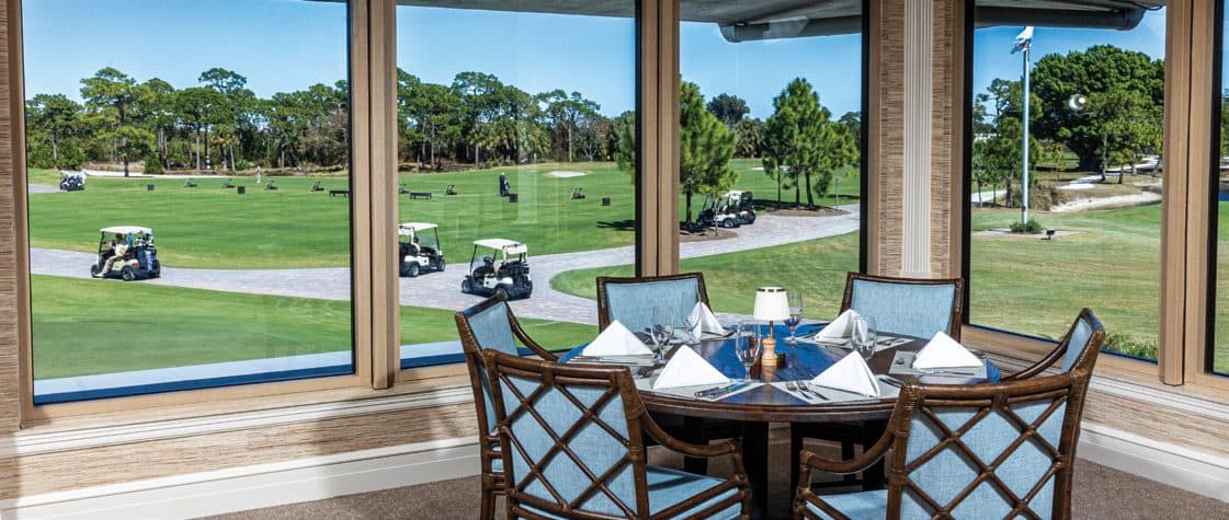 Hobe Sound Golf Club dining room with windows overlooking the course